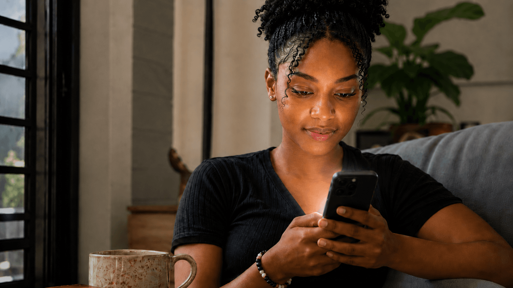 Young woman using Me2U app on her smartphone